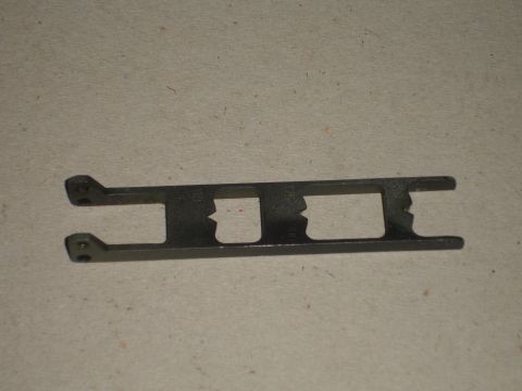1989 Ford Bronco - This metal bracket features two rectangular cutouts and mounting holes, likely for automotive use.