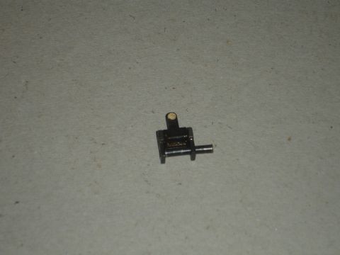1989 Ford Bronco - A small metal part is shown against a textured background.