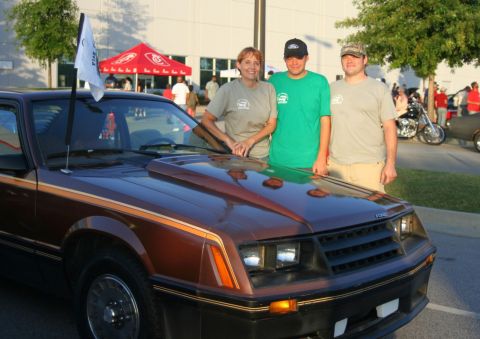 1980 Ford Mustang - A brown 1979 Ford Mustang is shown with three people posing in front of it.
