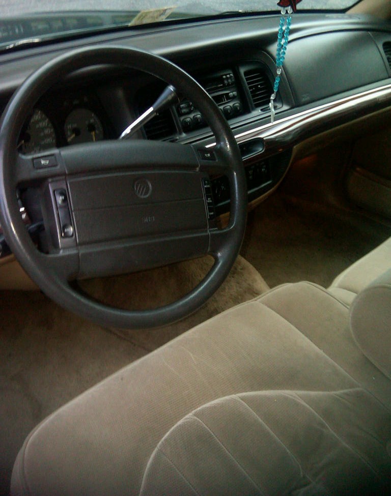 1995 Mercury Grand Marquis interior with tan seats and wood trim