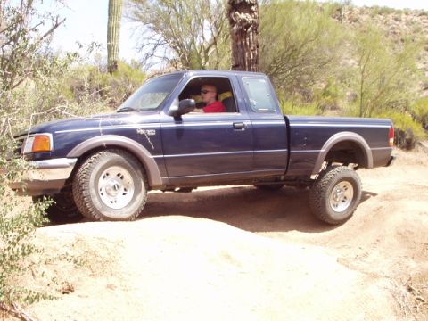 1993 Ford Bronco - Ford Ranger pickup truck driving off-road in a desert environment.
