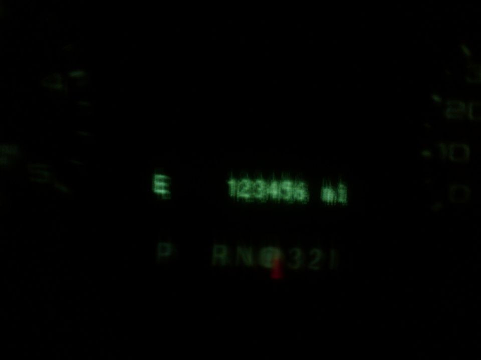 Dashboard gauges showing 123456 miles and PRND321 gear selection