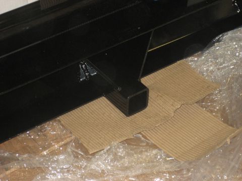 1978 Ford Bronco - Close-up of a black metal part, possibly a trailer hitch receiver, on protective wrapping.