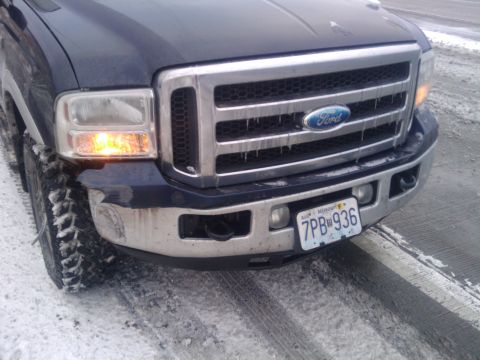 2005 Ford F-250 - A Ford Super Duty truck is shown from the front in a snowy environment. The grille and headlights are visible.