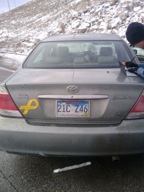 2005 Ford F-250 - Rear view of a gray Toyota Camry, a yellow awareness ribbon sticker and a license plate.
