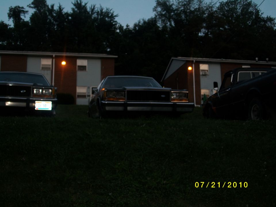 1987 Ford Crown Victoria LTD front view, dark sedan parked on grass