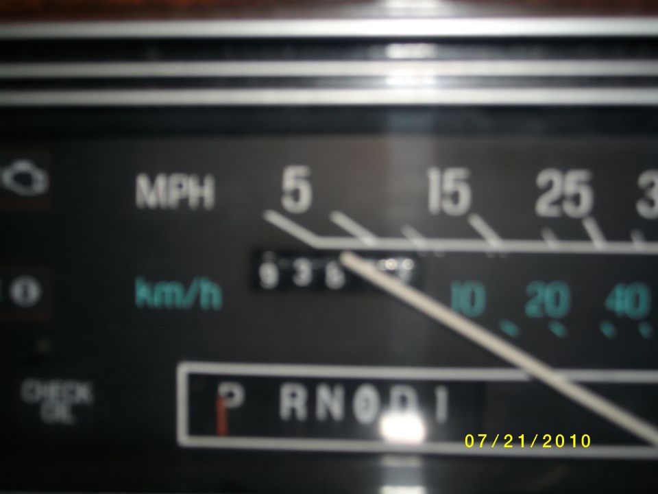 Close-up of a car's dashboard showing speedometer, odometer, and gear selector