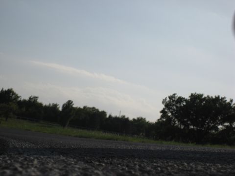 2008 Yamaha FZR1000 - A wide shot of a roadside scene under a cloudy sky, with the Supermotors.net logo in the lower right corner.