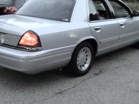 2000 Ford Crown Victoria - This silver 2000 Ford Crown Victoria is shown from the side, highlighting its side exit exhaust system.