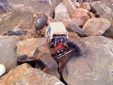 1996 Ford Bronco - RC rock crawler vehicle navigating a difficult rocky terrain.