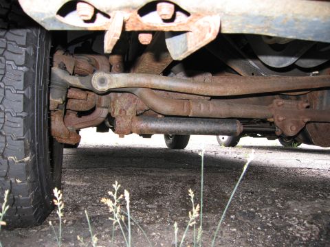 2001 Ford Crown Victoria - The underside of a vehicle shows significant rust on its suspension and exhaust components.