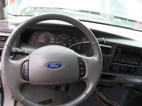 2001 Ford Crown Victoria - Interior view of a Ford vehicle's dashboard and steering wheel, showing the Ford logo and instrument cluster.