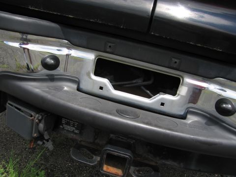 2001 Ford Crown Victoria - Close-up of a vehicle's rear bumper, showing a trailer hitch and exposed wiring.