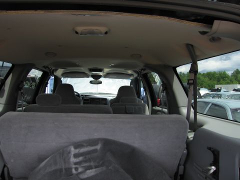 2001 Ford Crown Victoria - Interior view of a 2003 Ford Excursion, showing the front seats and dashboard, with other vehicles visible in the background.