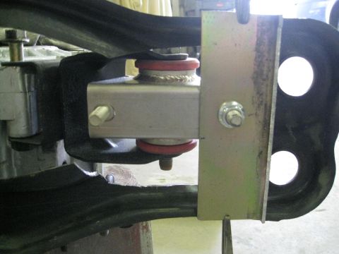 1994 Ford Probe - This image shows a close-up view of a vehicle's suspension system, highlighting a metal bracket and red bushings.
