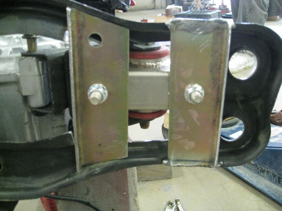 Close-up of a vehicle's suspension component with metal brackets and bolts