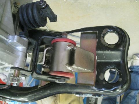 1994 Ford Probe - This image shows a close-up view of a vehicle's suspension system, focusing on a specific part with red bushings.