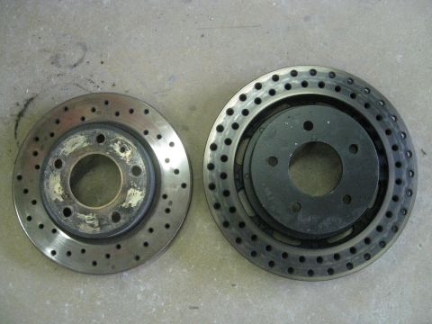 1994 Ford Probe - Comparison of two different vented brake rotors, one showing wear on its central hub.