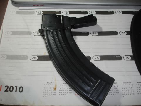1989 Ford Bronco - A black gun magazine is placed on top of a calendar from the year 2010.