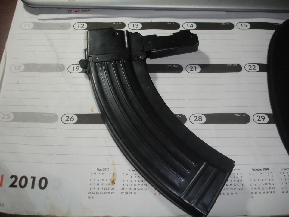 Black gun magazine resting on a 2010 calendar page