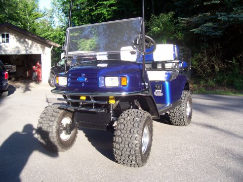 1978 Ford F-150 - This modified golf cart features a Ford emblem, suggesting a custom modification rather than a factory vehicle.