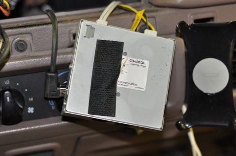 1996 Ford Bronco - Close-up of a car stereo component with model number CD-IB10G, secured with velcro.
