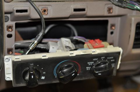 1996 Ford Bronco - Close-up of a car's interior climate control panel, showing the knobs and labels for various functions.