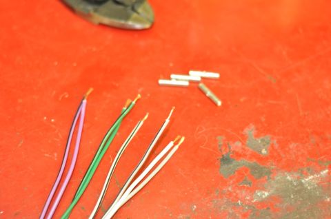 1996 Ford Bronco - Wires and crimp connectors are laid out on a red surface, possibly for electrical repair.