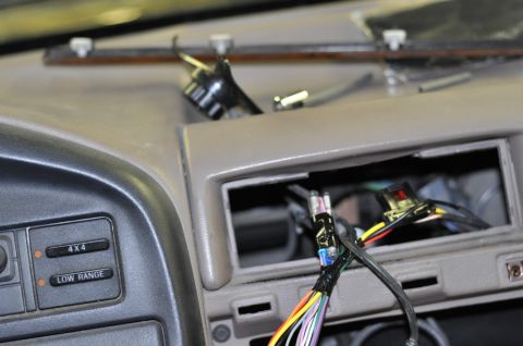 1996 Ford Bronco - Dashboard of a 1996 Ford Bronco with wiring exposed after radio removal.