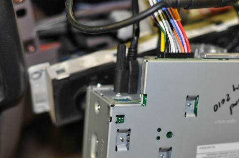 1996 Ford Bronco - Close-up view of car stereo wiring, showing USB and power connectors and a bundle of colorful wires.