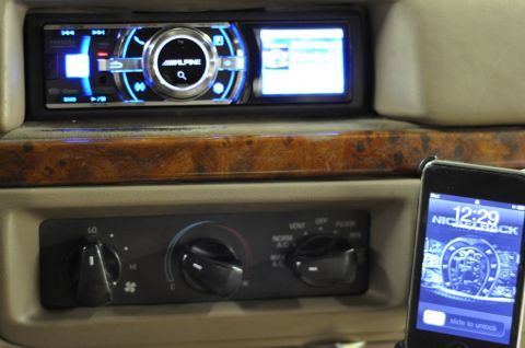 1996 Ford Bronco - Interior dash close-up showing an aftermarket Alpine single-DIN head unit with blue-lit ring controls and a small color display, mounted ab…
