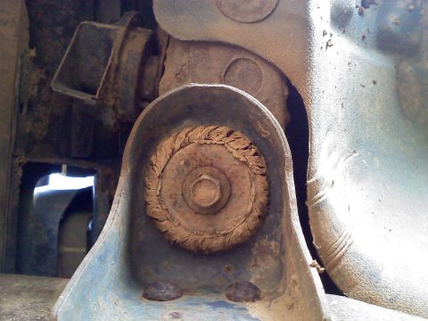 1990 Ford Bronco - This image shows a close-up view of a worn suspension component, likely from the underside of a vehicle.