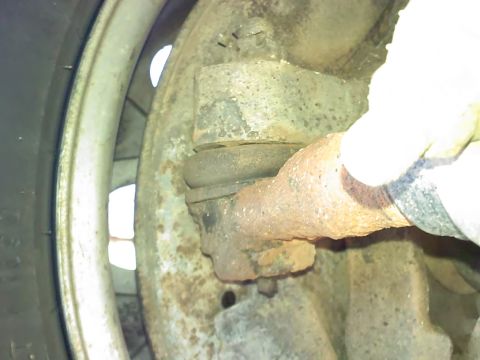 1990 Ford Bronco - Rusty ball joint assembly, likely from a truck or SUV's suspension system.