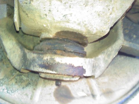 1990 Ford Bronco - A close-up view of a suspension part, rust and a watermark from Supermotors.net.