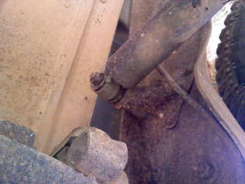 1990 Ford Bronco - Close-up of a rusted suspension component, likely from an older vehicle.