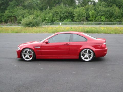 1998 Ford Crown Victoria - A red coupe with distinctive aftermarket wheels and a lowered stance is shown from the side.