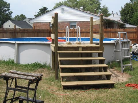 1994 Ford Bronco - A backyard scene an above-ground pool with a newly constructed wooden deck and steps.