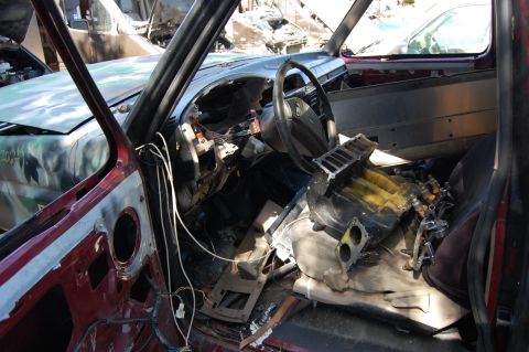 1994 Ford Bronco - Interior view of a heavily damaged vehicle with parts scattered and removed.