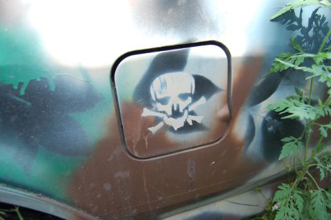 1994 Ford Bronco - A skull and crossbones sticker adorns the fuel door of a camouflaged vehicle.
