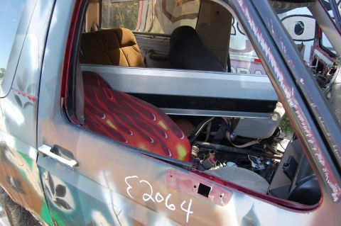 1994 Ford Bronco - The interior of a modified Ford Bronco shows custom flame decals and aftermarket seats.
