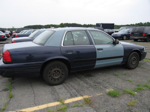2001 Ford Crown Victoria - Side view of a two-tone 2001 Ford Crown Victoria in a parking lot.