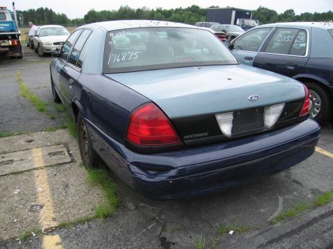 2001 Ford Crown Victoria - This 2001 Ford Crown Victoria is seen from the rear in a parking lot with other vehicles.
