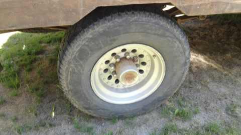 1989 Ford Bronco - A close-up view of a large wheel and part of the fender of a heavy-duty vehicle.