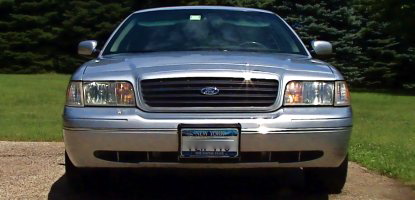 2000 Ford Crown Victoria - Front view of a silver 2000 Ford Crown Victoria, its distinctive grille and headlights.