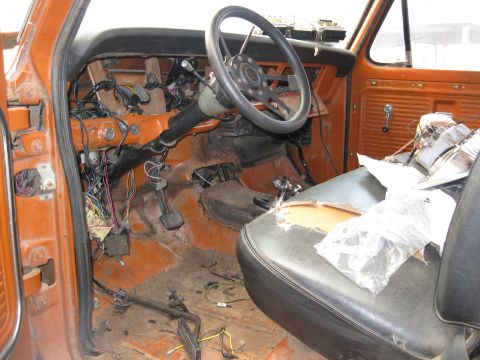 1969 Ford F-250 - The interior of a 1969 Ford F-250 shows extensive exposed wiring and a torn seat, indicating a project vehicle.