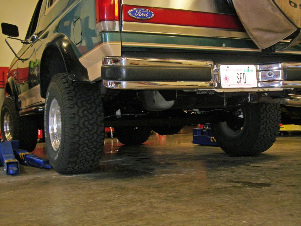 Rear view of a 1990 Ford Bronco with a spare tire cover and a Washington license plate reading SFD