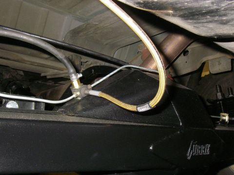1990 Ford Bronco - Braided fuel line and T-fitting assembly attached to a differential housing.
