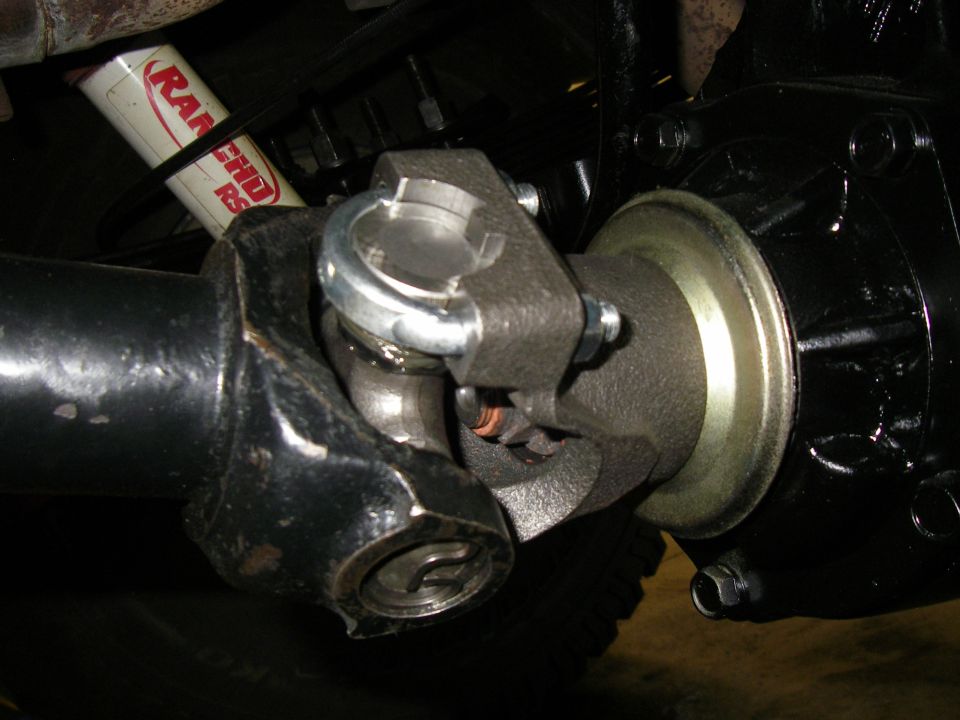 Driveshaft U-joint connected to differential housing, with Rancho RS5000 shock absorber visible