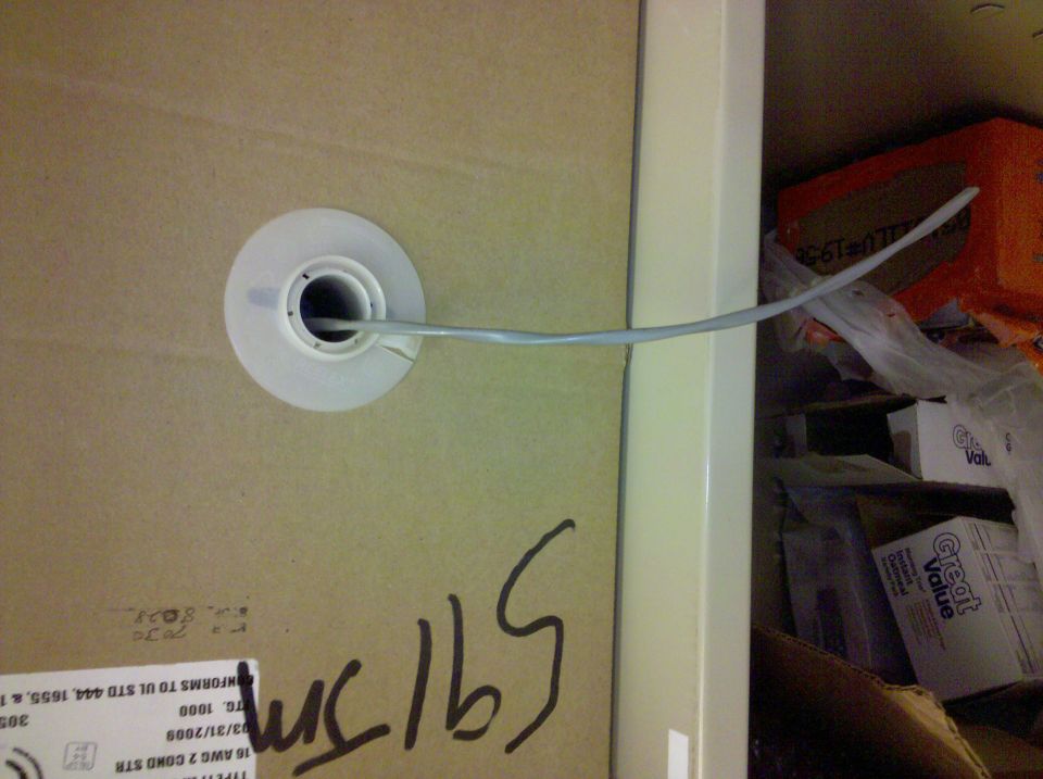 Cardboard spool box of white 16 AWG 2-conductor wire with lead pulled through feed hub