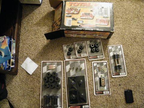 1982 Ford Bronco - A collection of suspension bushings and hardware, including a large kit labeled 'Total Suspension Kit'.